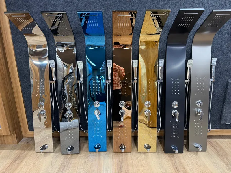 Row of imported stainless steel shower panels in assorted finishes